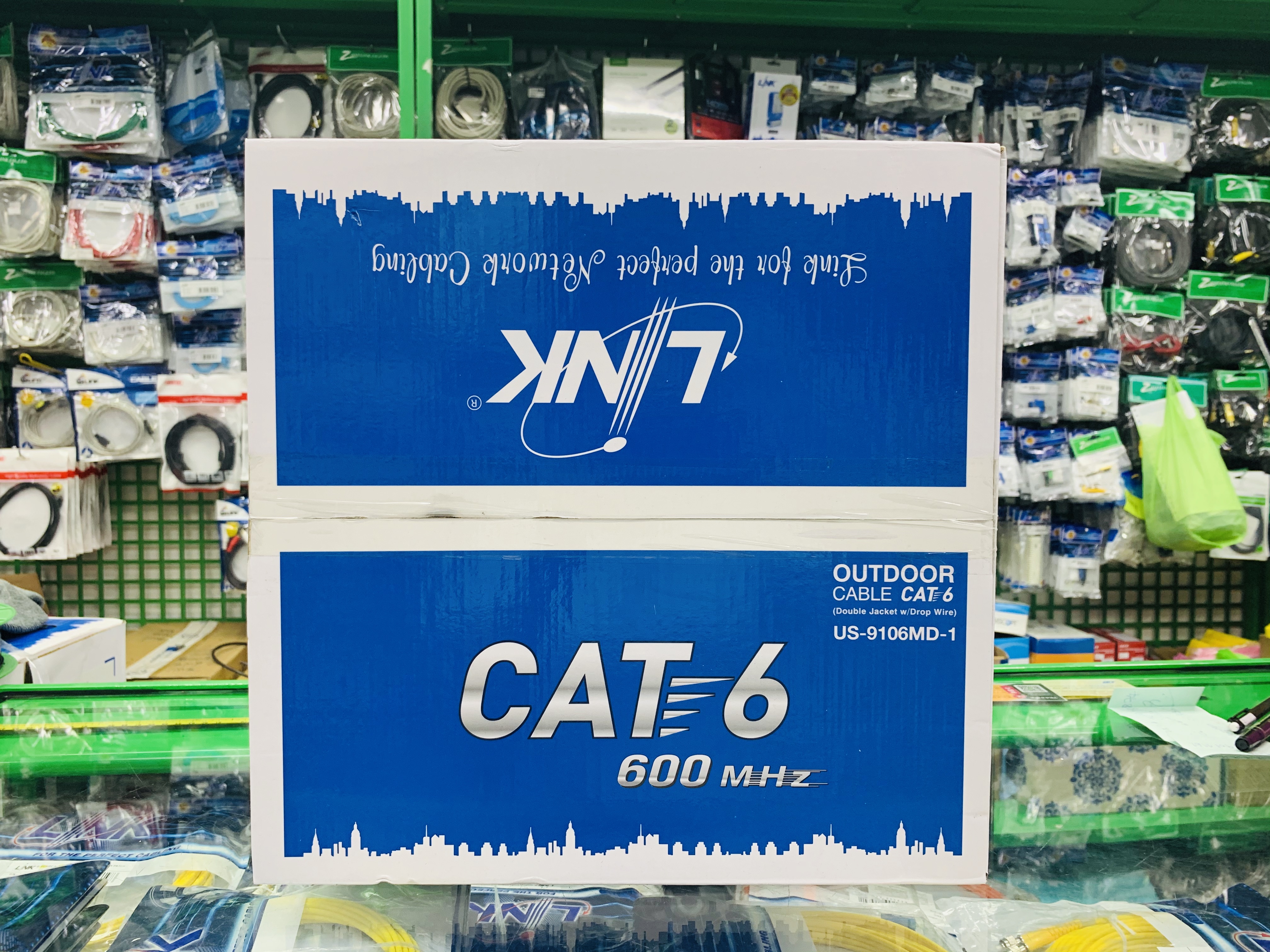 US-9106MD-1 CAT 6 UTP, PE OUTDOOR w/Cross Filler, 23 AWG, w/Drop Wire (Double Jacket), สีดำ 100 M./Reel in Bx.